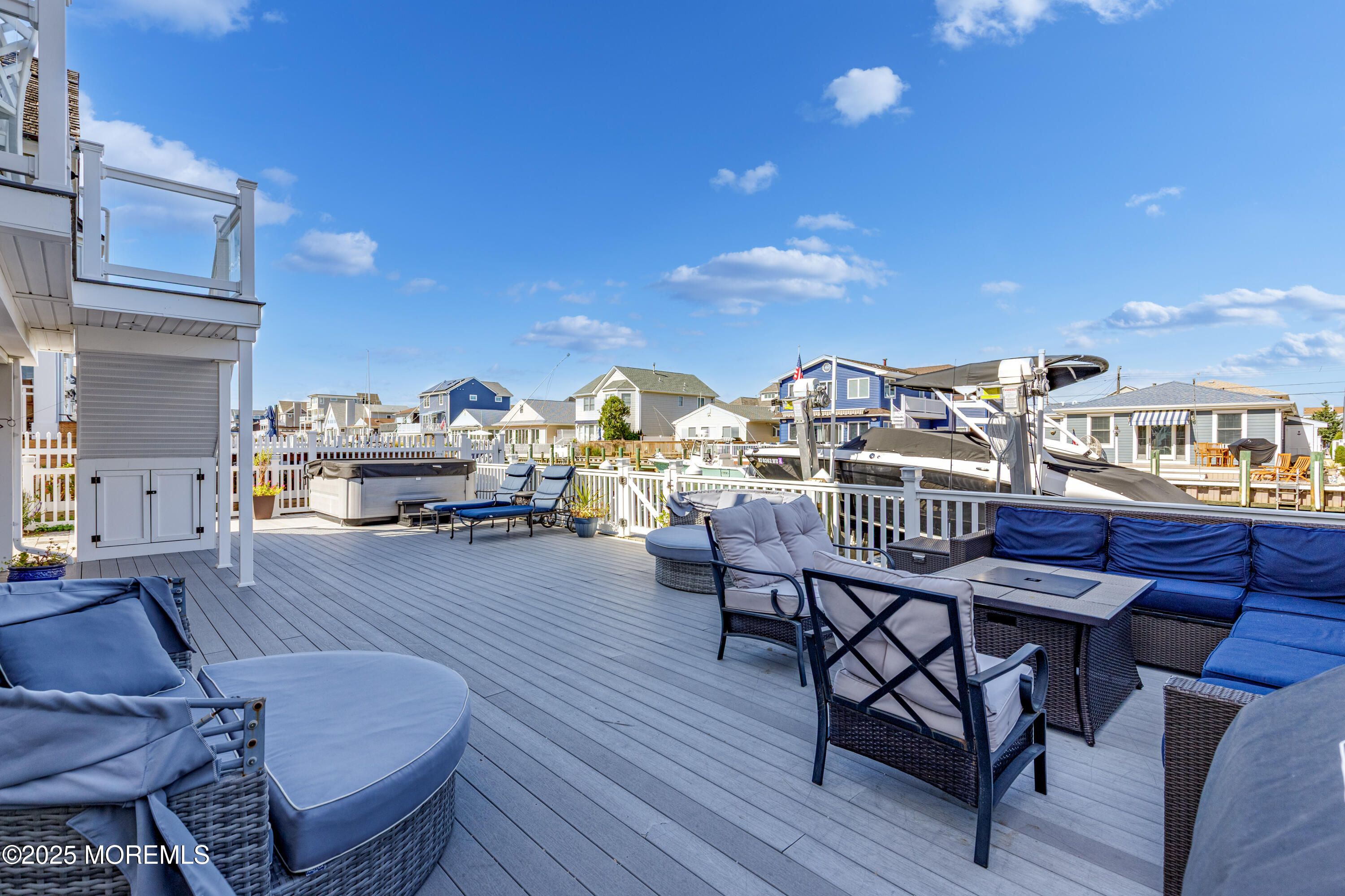 206 North Lagoon Road, Unit SUMMER 2026 Lavallette, NJ 08735 - Photo 28 of 50 a view of a balcony dining table and chairs