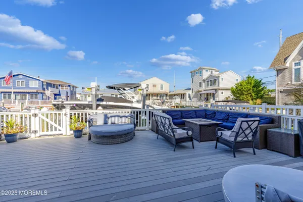 a view of a roof deck with table and chairs