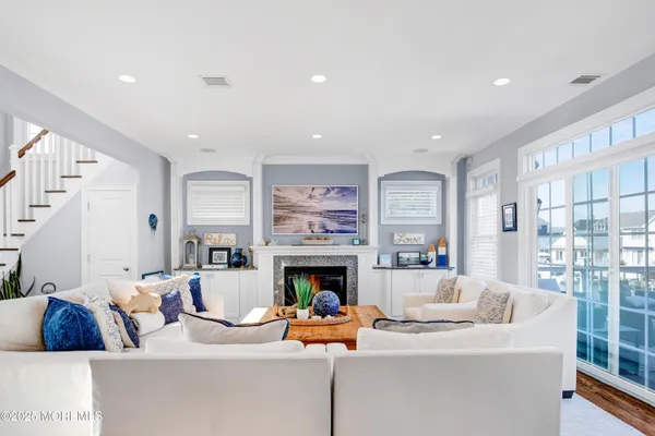 a living room with furniture large window and a fireplace