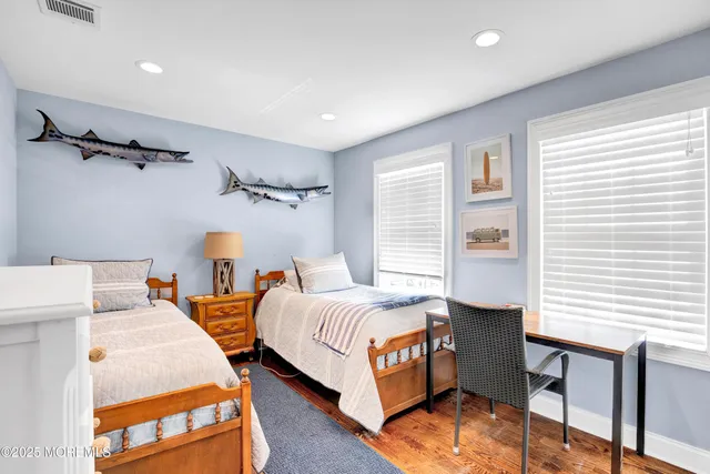 a bedroom with two beds and a window