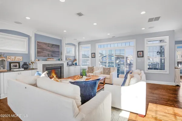 a living room with fireplace furniture and a wooden floor