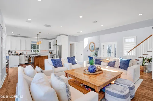 a living room with furniture and a view of kitchen