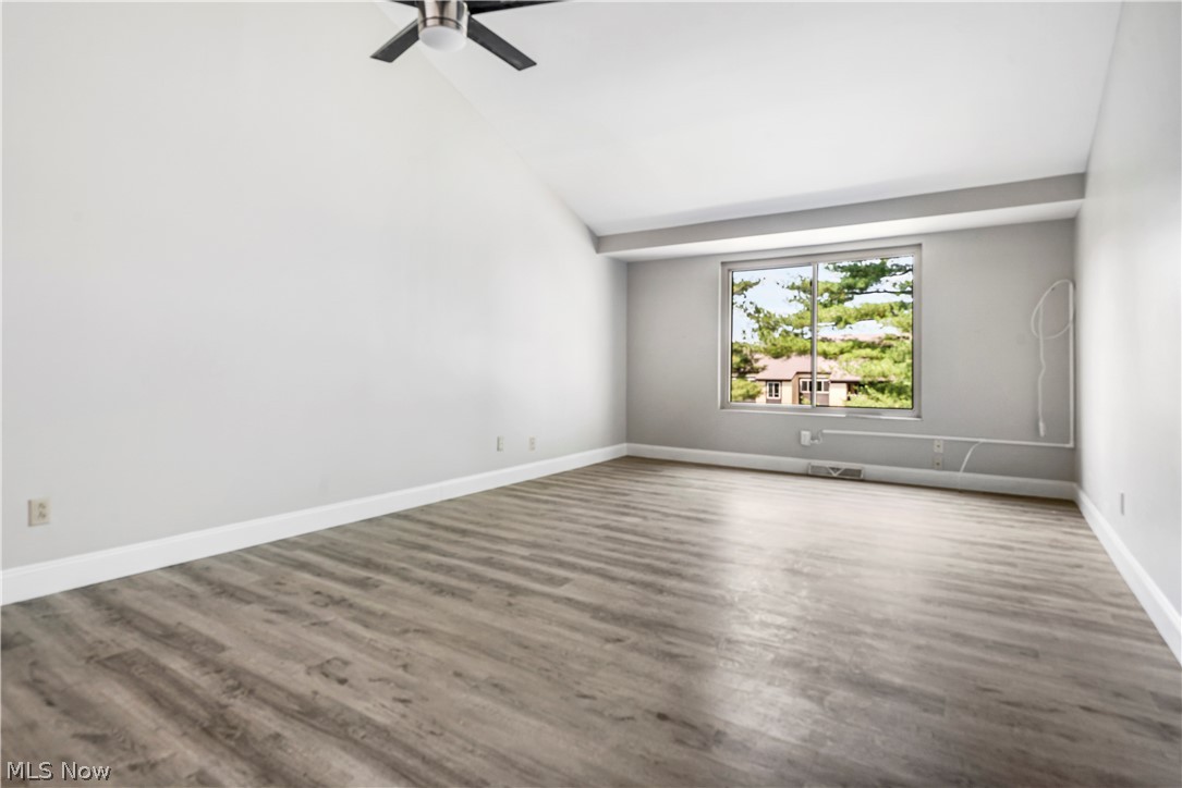 3428 South Smith Road Fairlawn, OH 44333 - Photo 8 of 30 Spare room with hardwood / wood-style flooring, ceiling fan, and vaulted ceiling