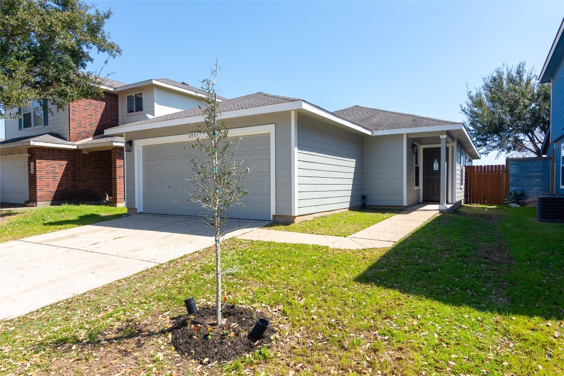 2803 Crownover Street Austin, TX 78725 - Photo 1 of 1 a front view of a house with a yard and garage