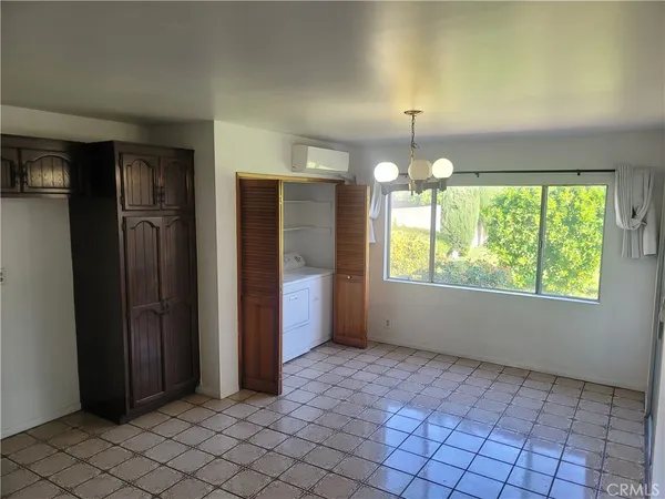 an empty room with windows and painted walls