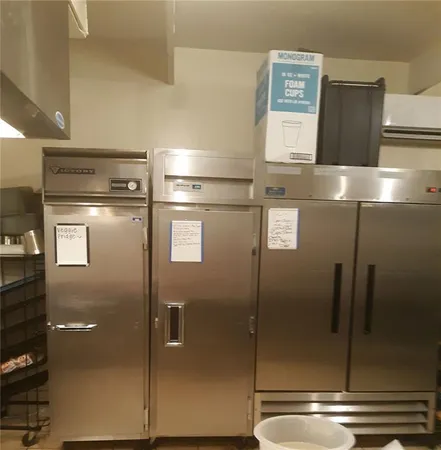 a kitchen with a stove and a dining table