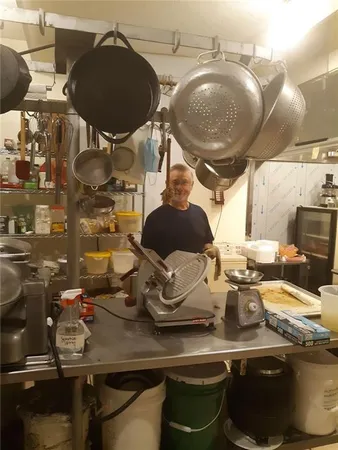 a kitchen with a stove and chairs