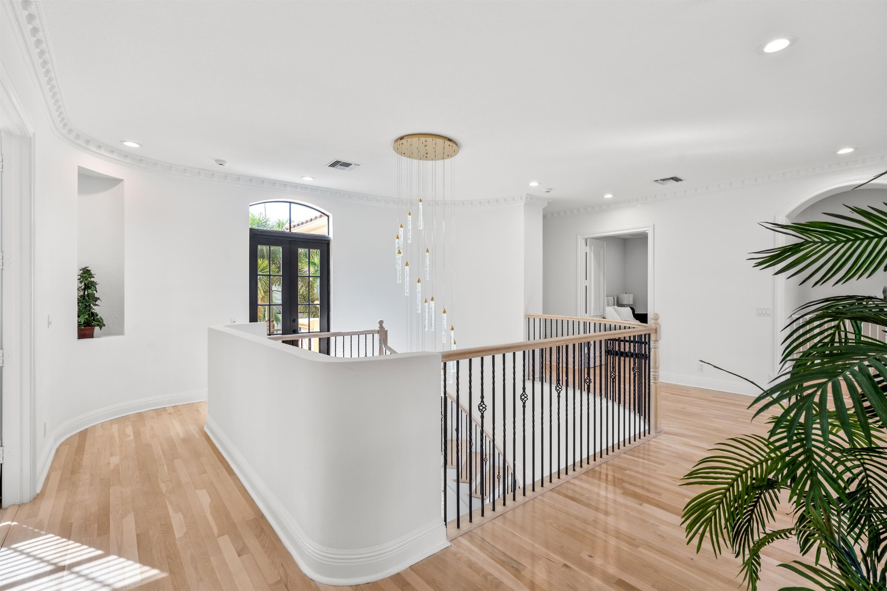 17894 Monte Vista Drive Boca Raton, FL 33496 - Photo 14 of 47 a view of a hallway with wooden floor and staircase