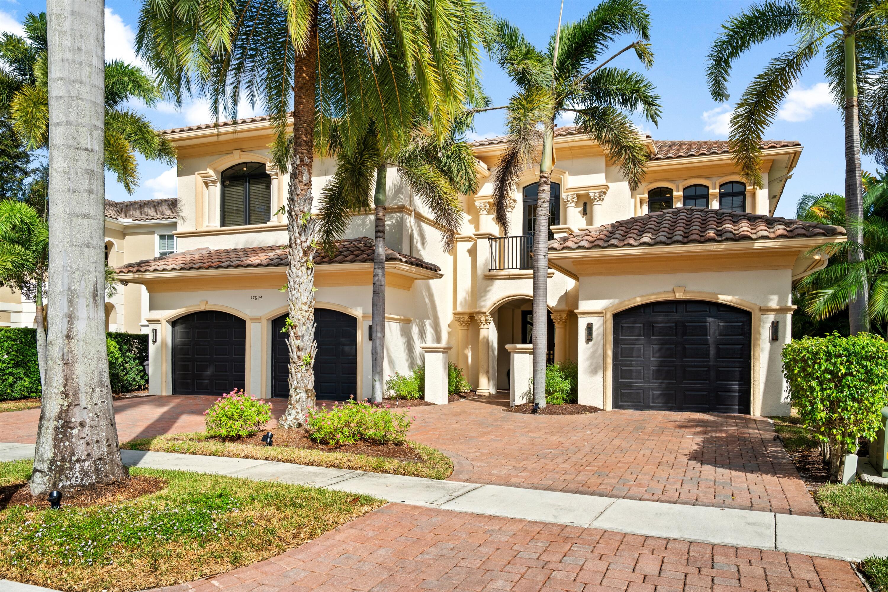 17894 Monte Vista Drive Boca Raton, FL 33496 - Photo 2 of 47 a front view of a house with a garden