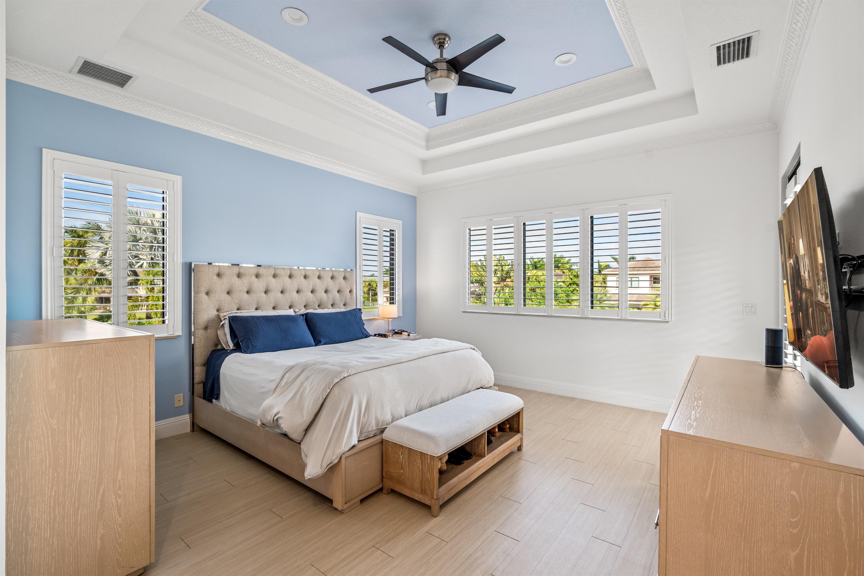 17894 Monte Vista Drive Boca Raton, FL 33496 - Photo 24 of 47 a bedroom with a bed and a flat screen tv on dresser