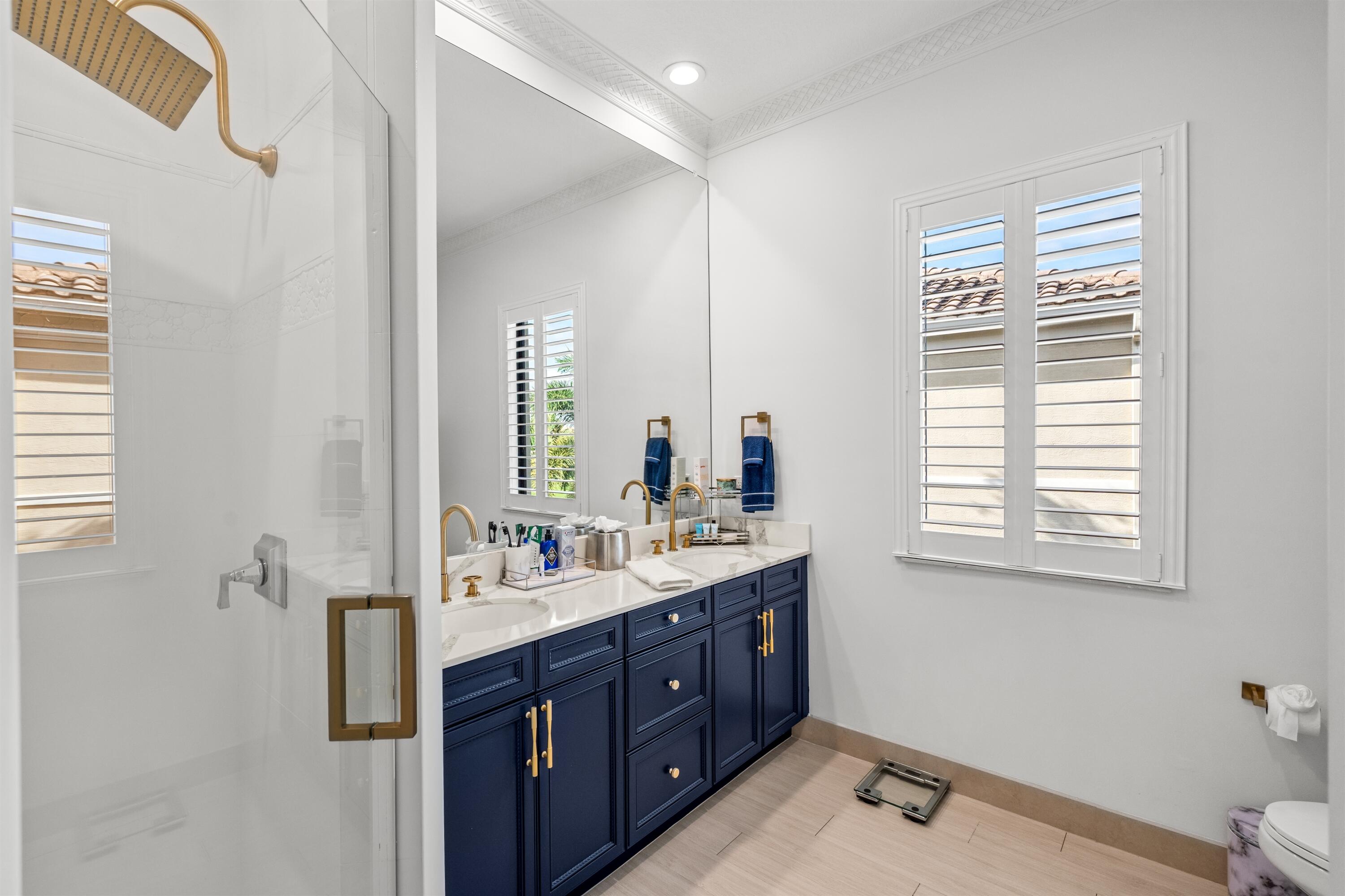 17894 Monte Vista Drive Boca Raton, FL 33496 - Photo 25 of 47 a spacious bathroom with a double vanity sink a mirror and a toilet