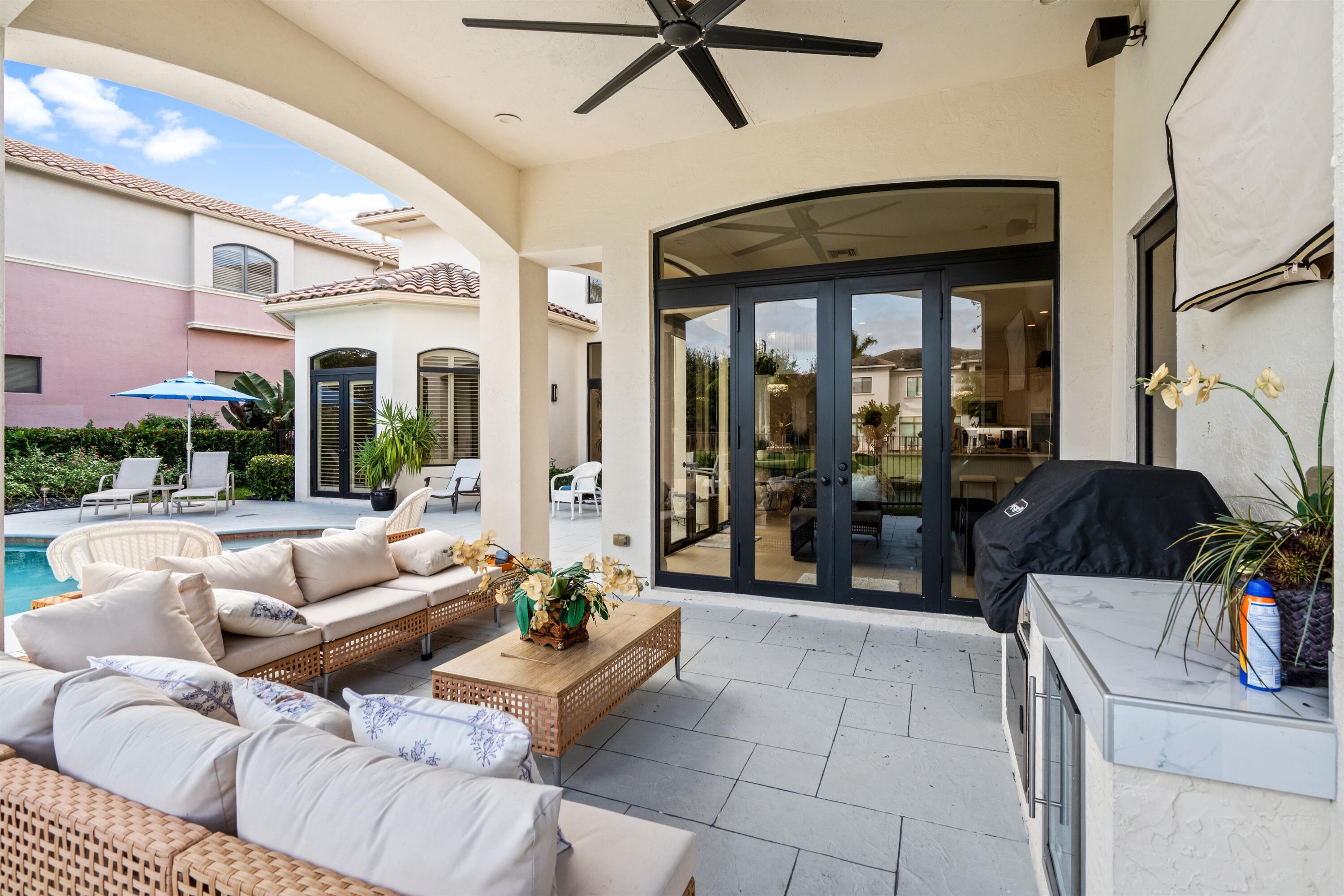 17894 Monte Vista Drive Boca Raton, FL 33496 - Photo 26 of 47 a living room with furniture and a floor to ceiling window