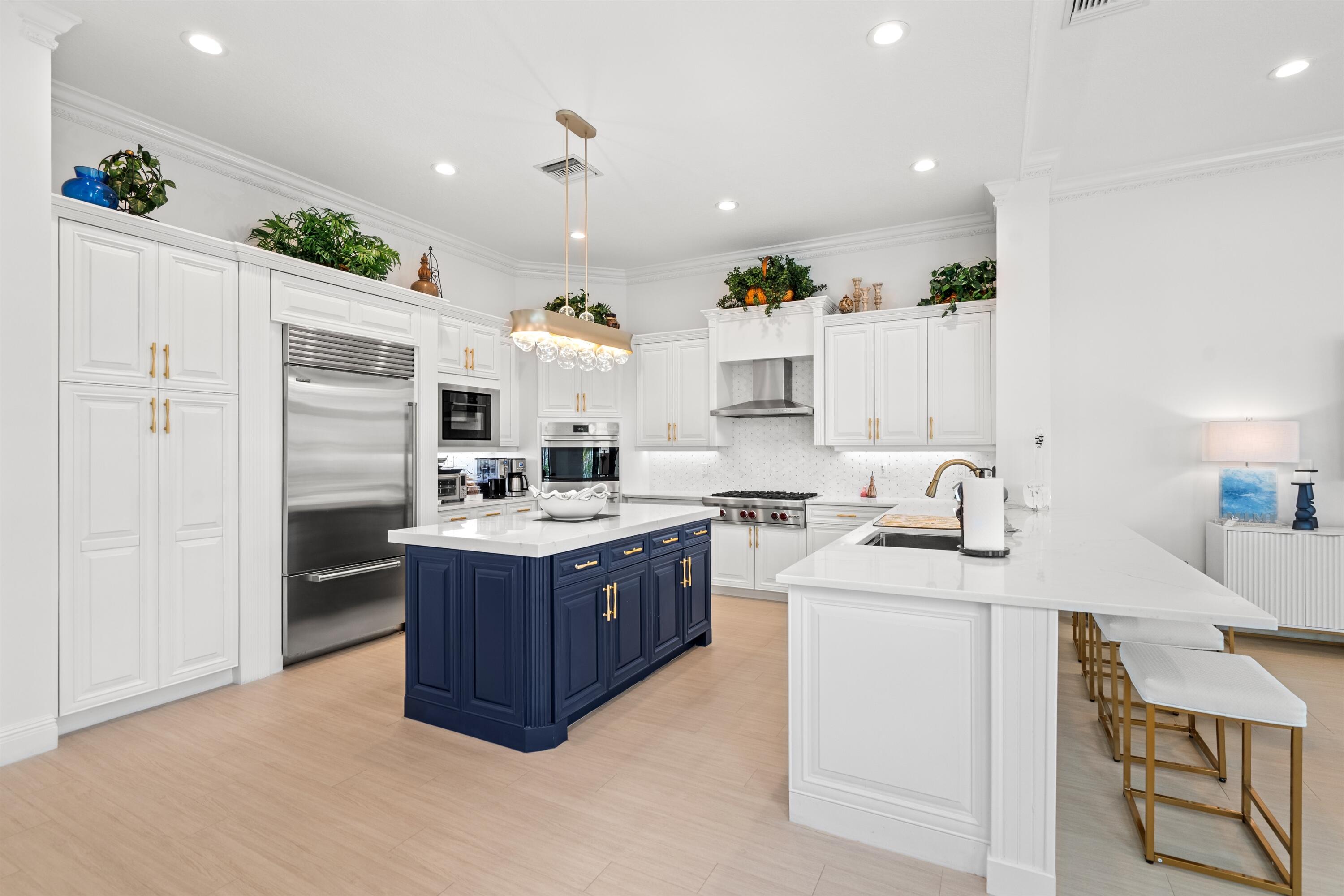 17894 Monte Vista Drive Boca Raton, FL 33496 - Photo 6 of 47 a large kitchen with kitchen island a sink stainless steel appliances and cabinets