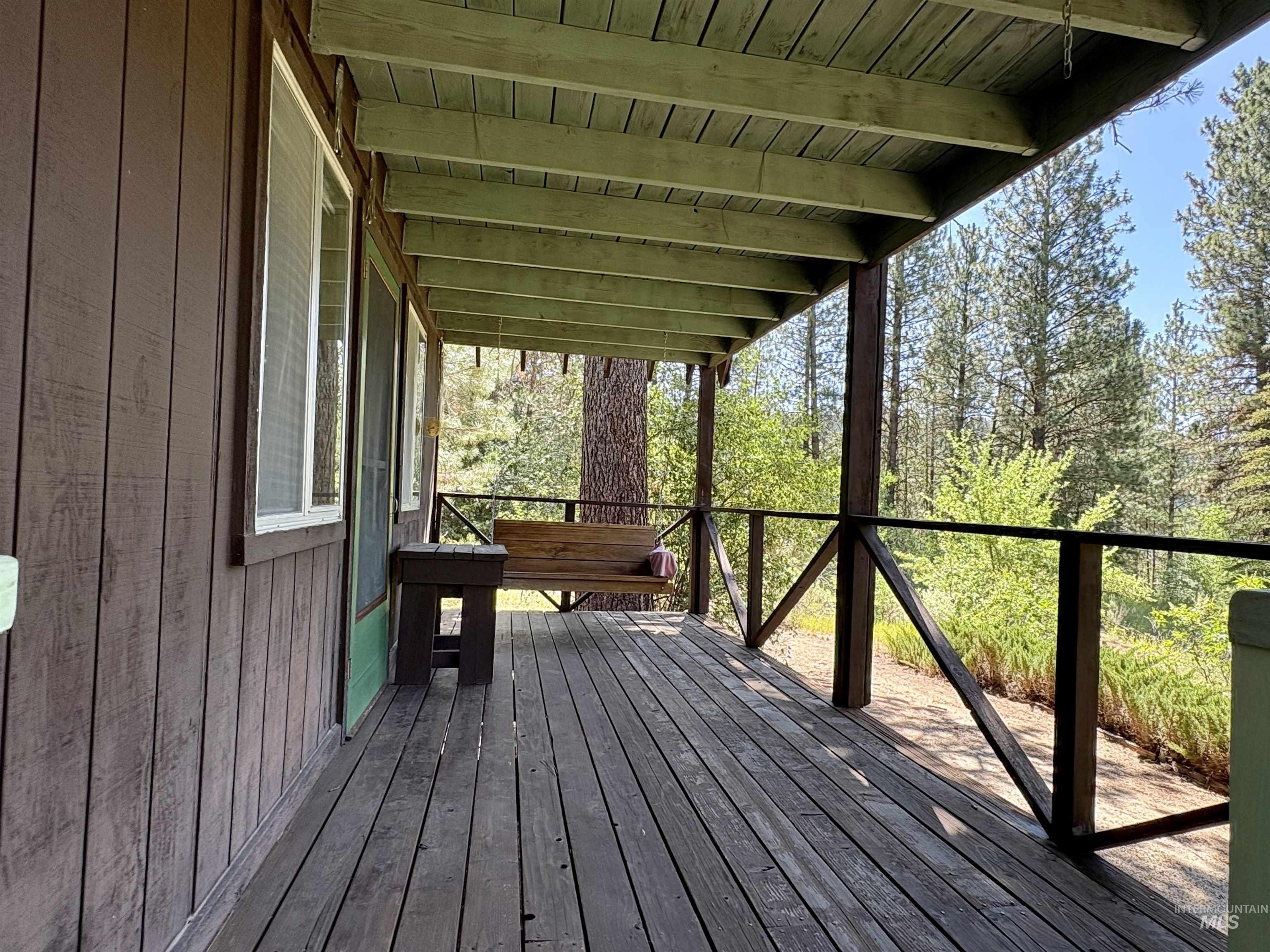 1100 Strawberry Loop Road Mountain Home, ID 83647 - Photo 19 of 20 Storage shed with a green corrugated roof and light brown siding, framed by mature trees