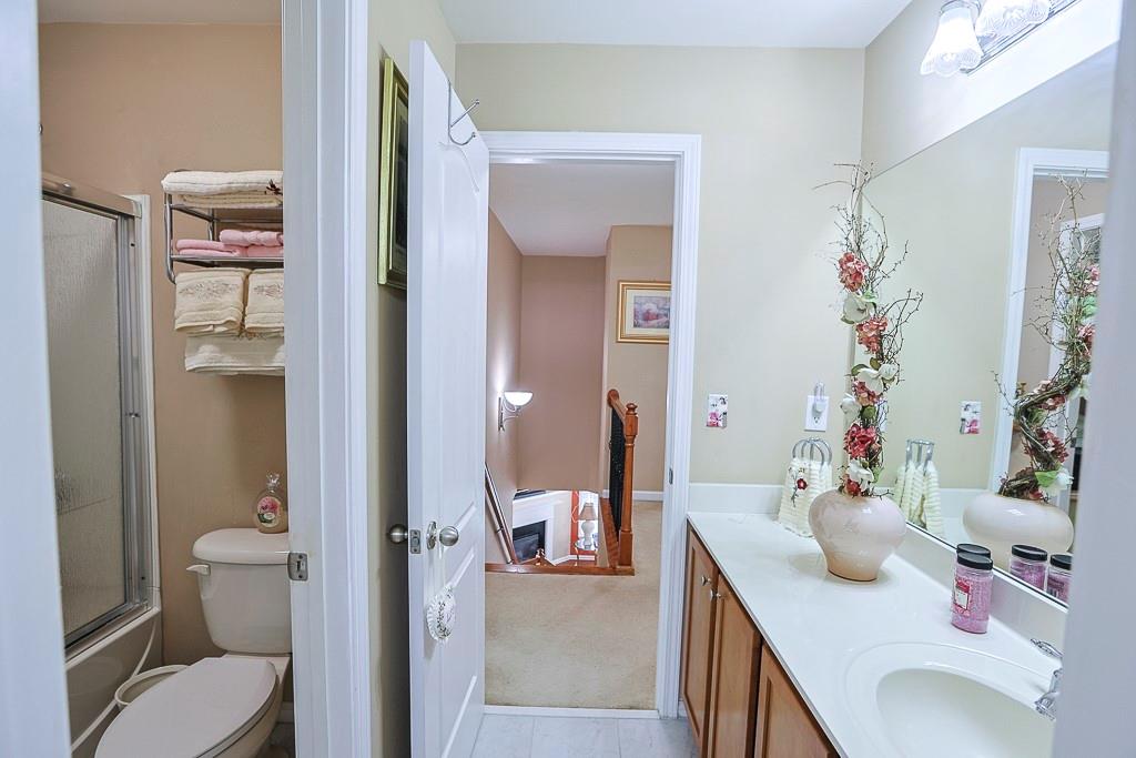 300 Hampton Place Canton, GA 30115 - Photo 39 of 82 a bathroom with a sink and mirror with toilet