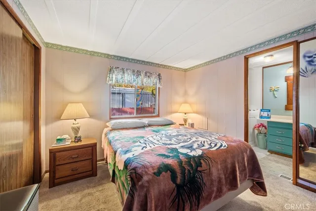 a bedroom with a large bed and a window