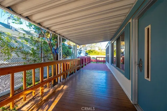 a view of backyard with wooden fence and large trees