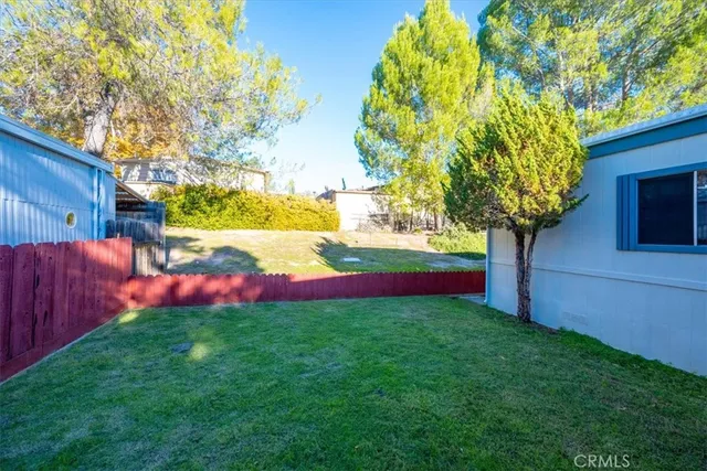 a view of backyard with seating area and slide