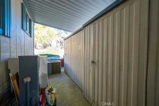 a view of a house with a yard and table and chairs under an umbrella