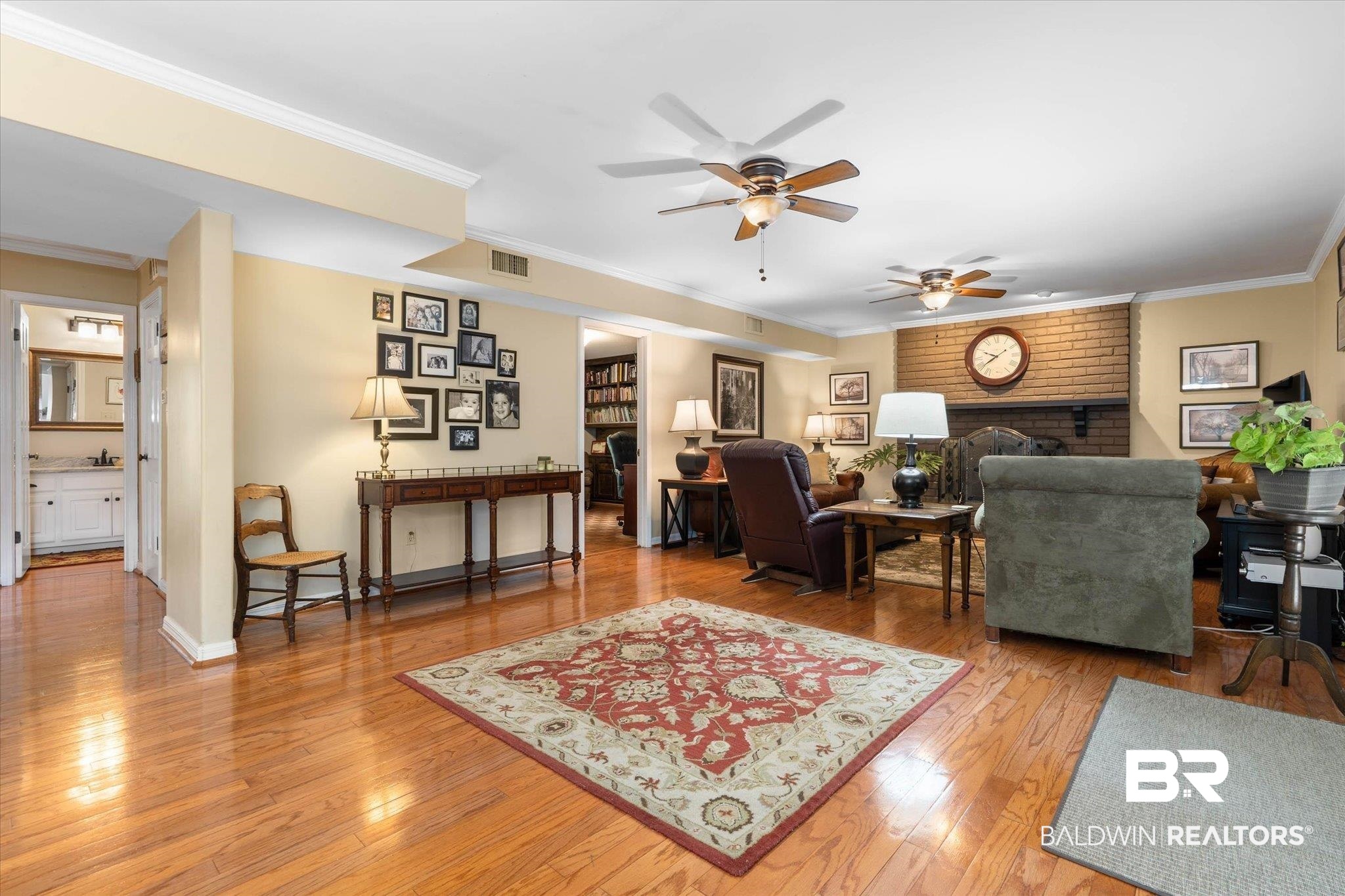 559 East Cumberland Road Mobile, AL 36608 - Photo 11 of 48 Living area with a fireplace, crown molding, light wood-type flooring, and ceiling fan