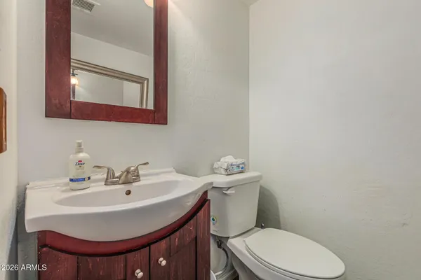 a white toilet sitting next to a bathroom sink
