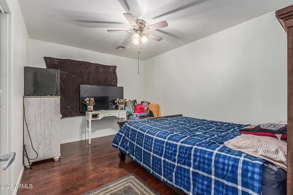 a bedroom with a bed and a chandelier