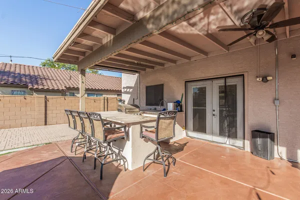 a view of a patio with dining table and chairs with wooden floor
