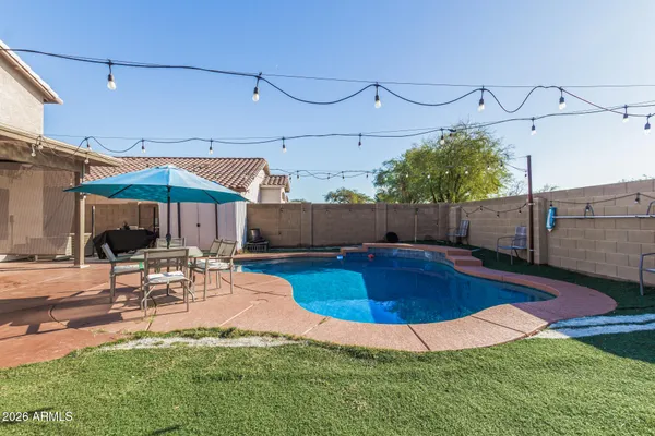 a view of a swimming pool with a patio