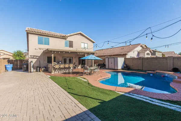 a front view of house with swimming pool yard and outdoor seating