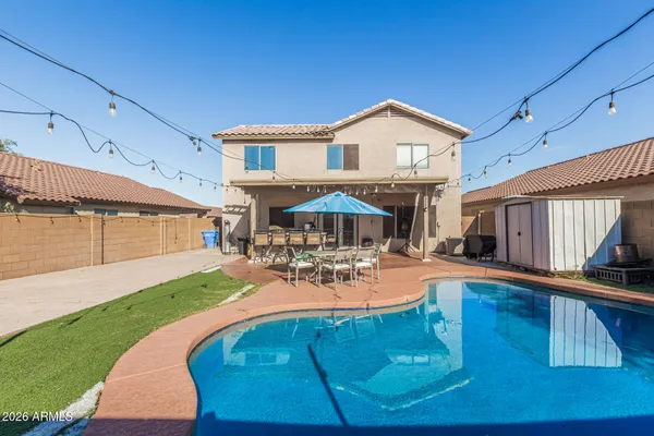 a view of a house with backyard and sitting area