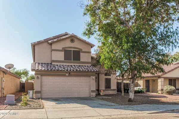 a front view of a house with a garage