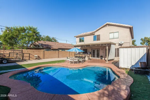 a view of a house with swimming pool and sitting area