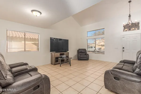 a bedroom with furniture and a flat screen tv