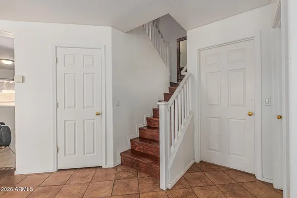 a view of entryway with stairs and white door
