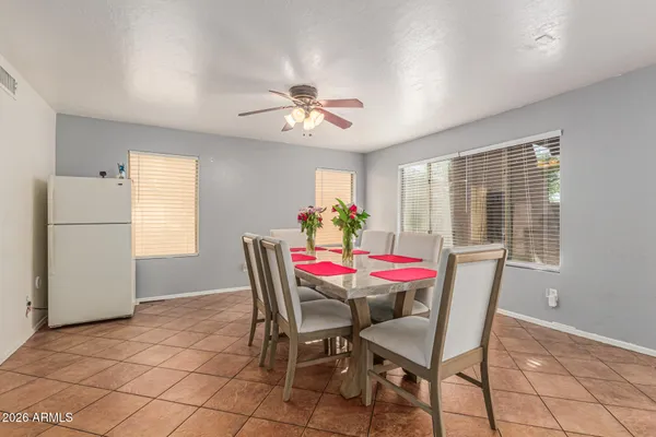 a view of a dining room with furniture and a chandelier