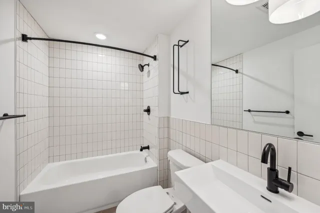 a bathroom with a sink a toilet and a bathtub