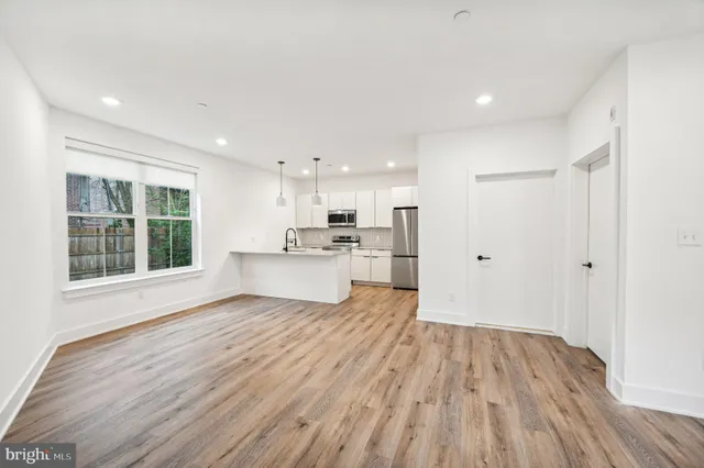 a view of kitchen with wooden floor and window