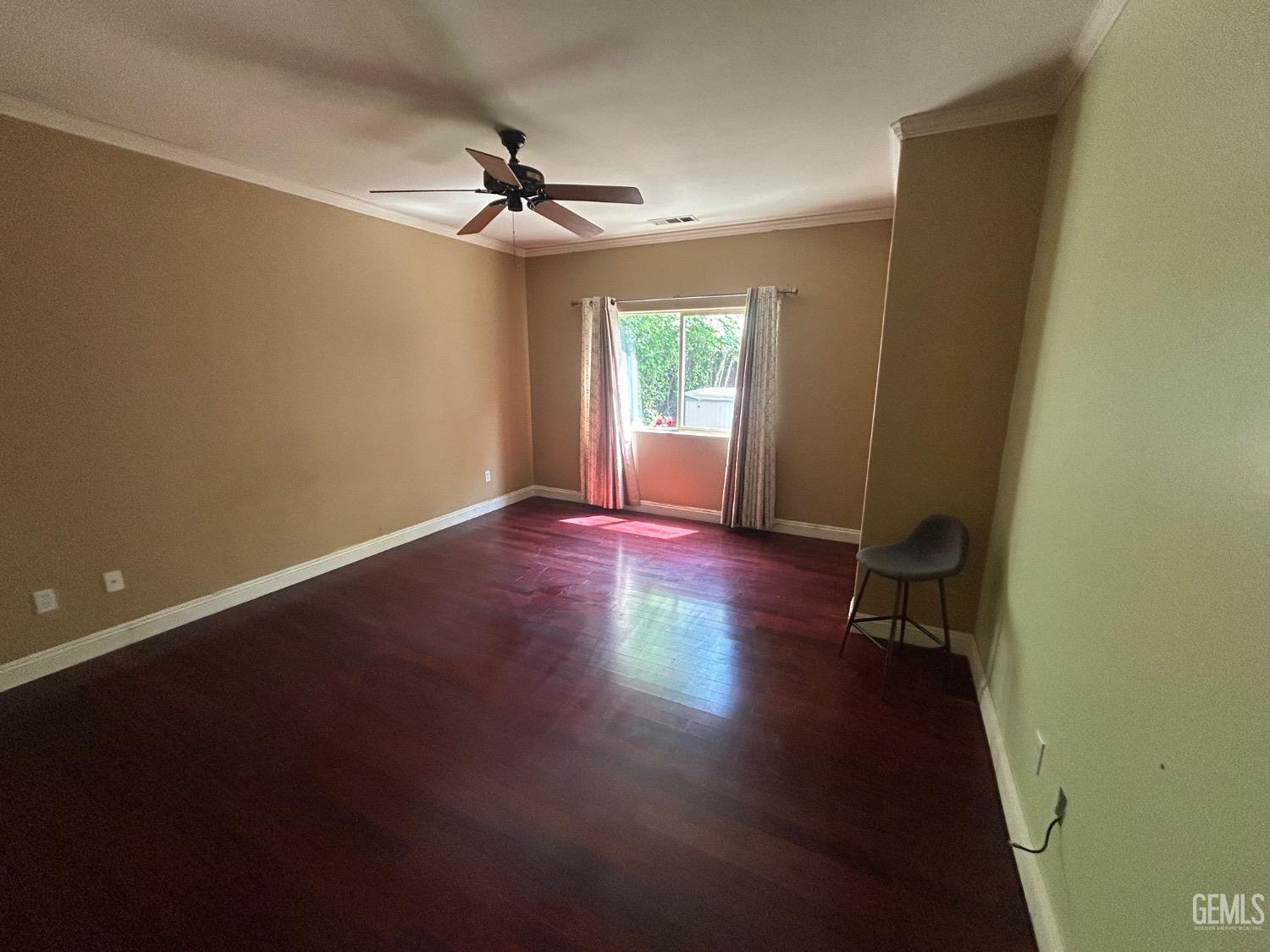 Undisclosed Address Bakersfield, CA 93312 - Photo 14 of 15 an empty room with wooden floor a ceiling fan and windows