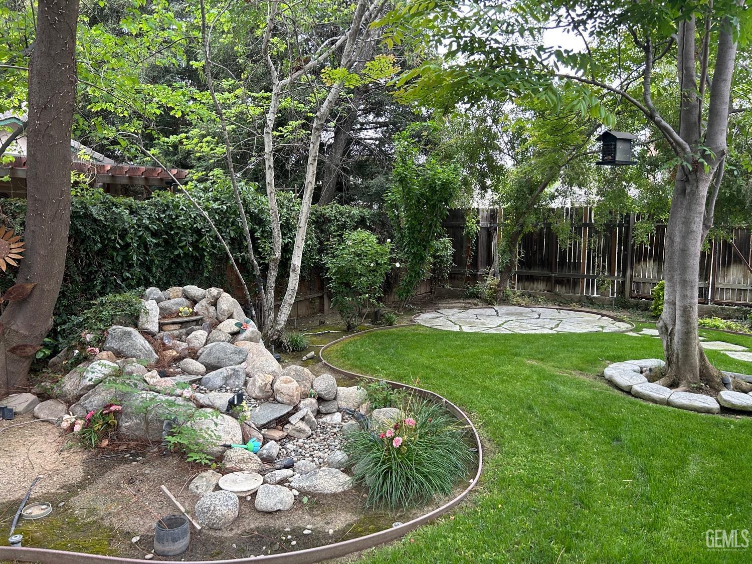 Undisclosed Address Bakersfield, CA 93312 - Photo 5 of 15 a view of a backyard with large trees