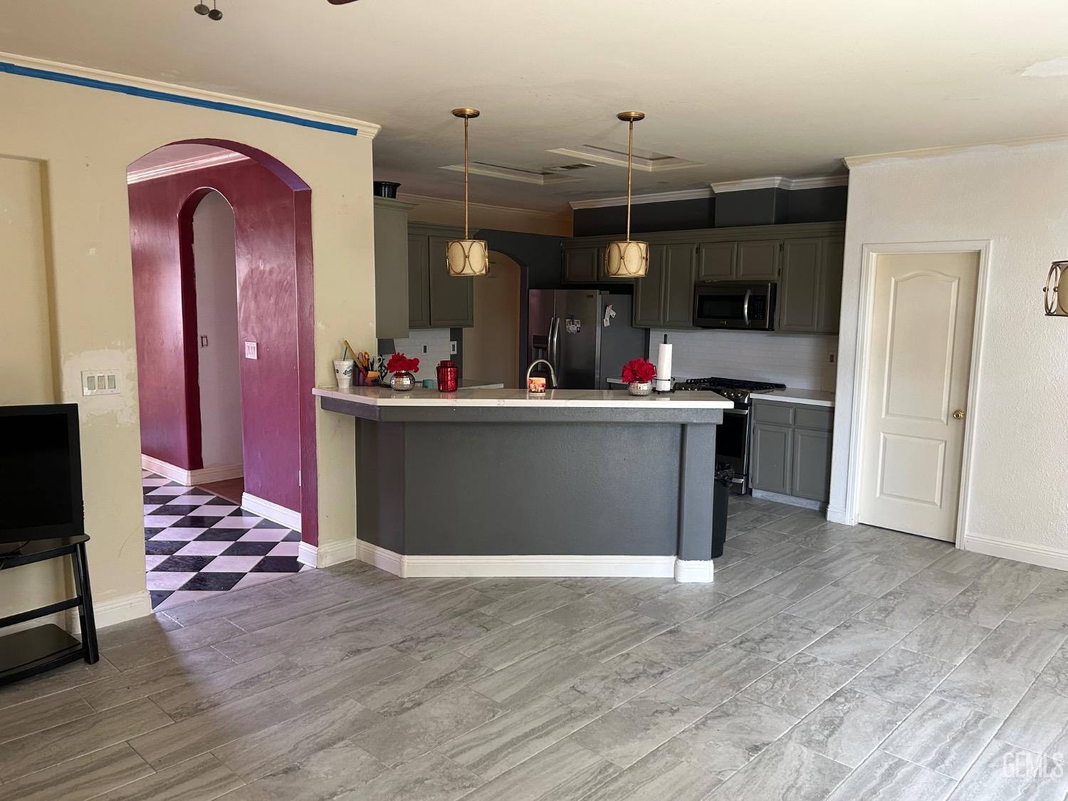 Undisclosed Address Bakersfield, CA 93312 - Photo 9 of 15 a view of living room with kitchen island furniture and wooden floor