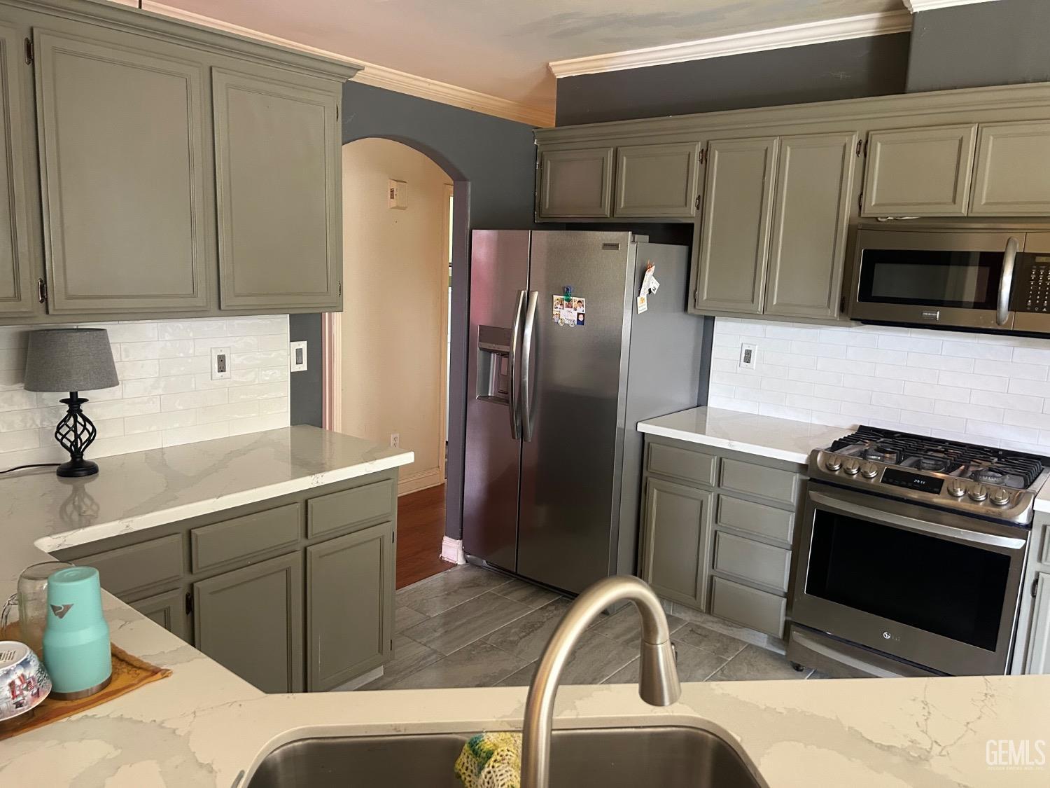 Undisclosed Address Bakersfield, CA 93312 - Photo 10 of 15 a kitchen with stainless steel appliances a refrigerator stove and sink