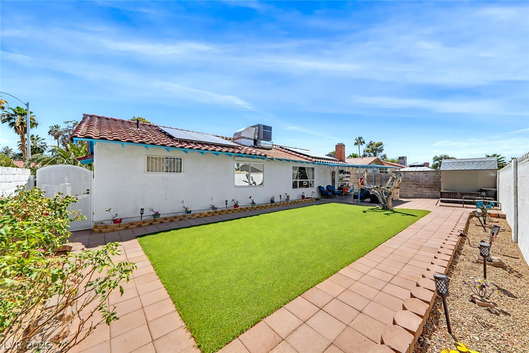 3107 Trueno Road Henderson, NV 89014 - Photo 32 of 37 A well-maintained outdoor space with vibrant green turf and a functional storage shed.