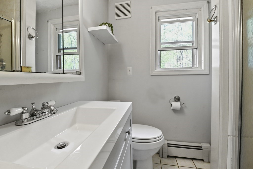 125 Lower Gore Road Webster, MA 01570 - Photo 12 of 42 a bathroom with a sink a toilet and a window