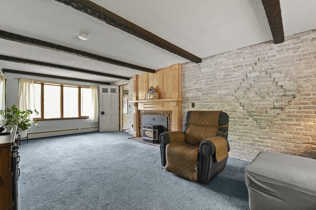 125 Lower Gore Road Webster, MA 01570 - Photo 6 of 42 a living room with furniture windows and a fireplace