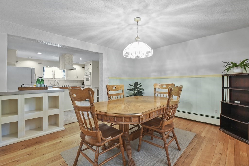 125 Lower Gore Road Webster, MA 01570 - Photo 7 of 42 a view of a dining room with furniture wooden floor and chandelier