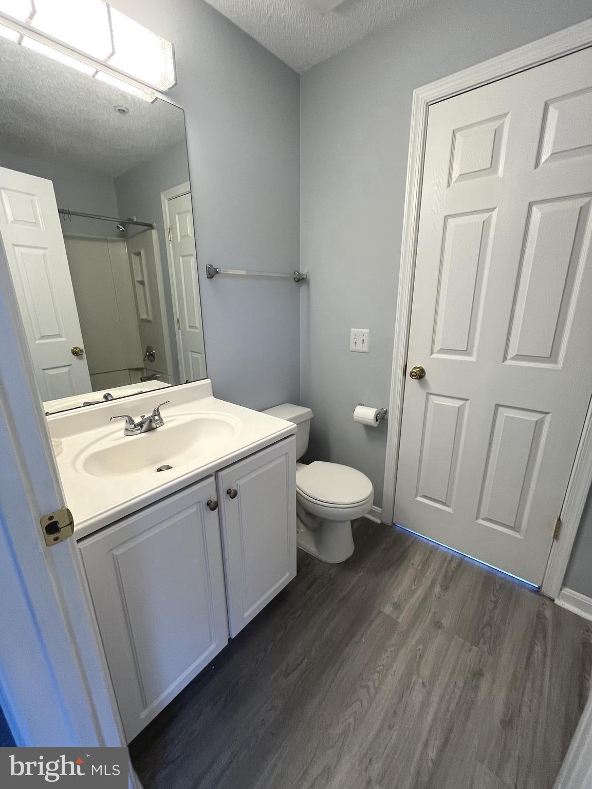 10019 Vanderbilt Circle, Unit 10 Rockville, MD 20850 - Photo 13 of 22 a bathroom with a sink and mirror with toilet