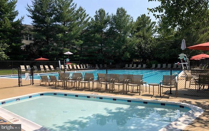 10019 Vanderbilt Circle, Unit 10 Rockville, MD 20850 - Photo 16 of 22 a view of a swimming pool with a patio