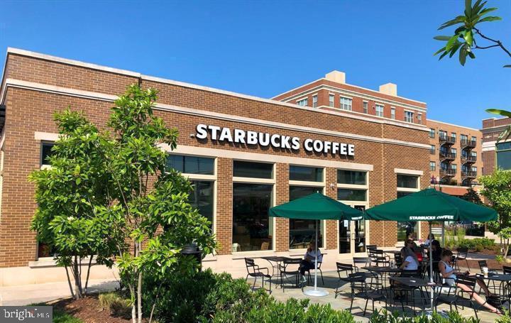 10019 Vanderbilt Circle, Unit 10 Rockville, MD 20850 - Photo 20 of 22 a view of a cafe with a table and chairs under an umbrella