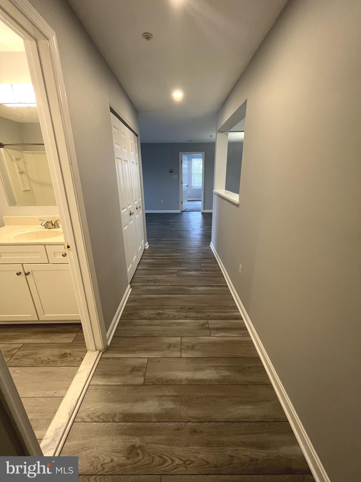 10019 Vanderbilt Circle, Unit 10 Rockville, MD 20850 - Photo 3 of 22 a view of a hallway with wooden floor and staircase