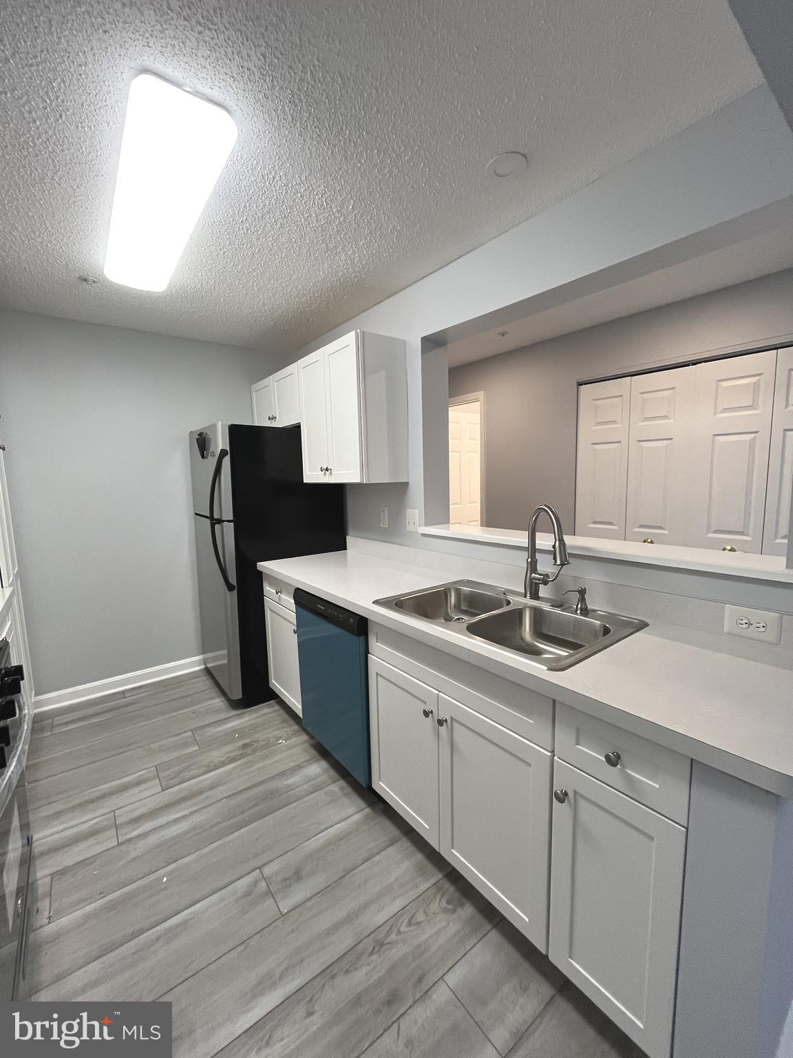 10019 Vanderbilt Circle, Unit 10 Rockville, MD 20850 - Photo 6 of 22 a kitchen with a sink and cabinets